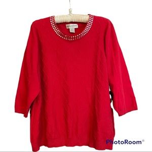 Red sweater with silver embellishments along the collar